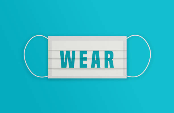 istock White Protective Mask with Wear message over the blue background. 1225008844