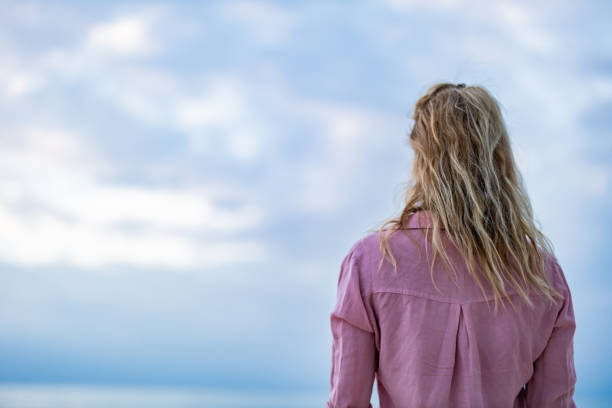 istock Rear view of a woman looking at view from beach. 1225008879