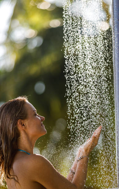 istock Young smiling woman taking a shower in nature. 1225010020