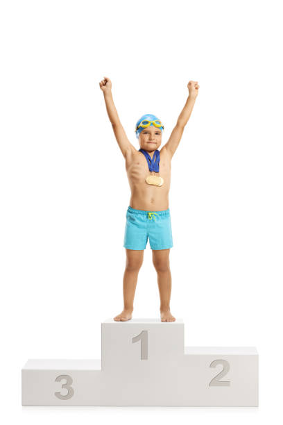 istock Young boy swimmer champion on a winners pedestal 1225010223