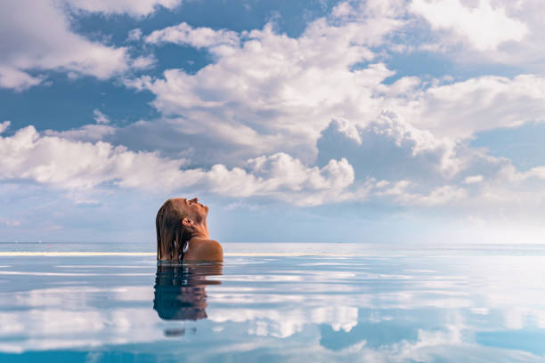 istock Woman spending her summer day in an infinity pool. 1225010443
