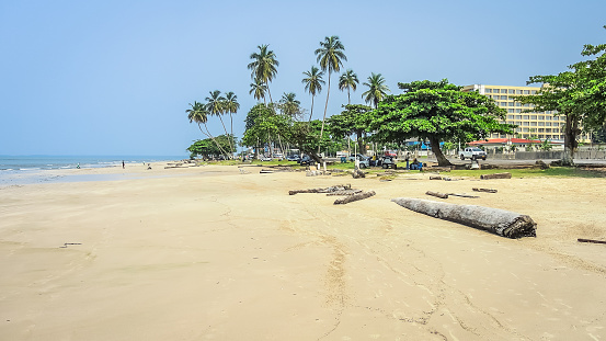 Panoramic view of the paradisiacal beach with tropical trees and clear and fine sand of Libreville, capital of the state of Gabon