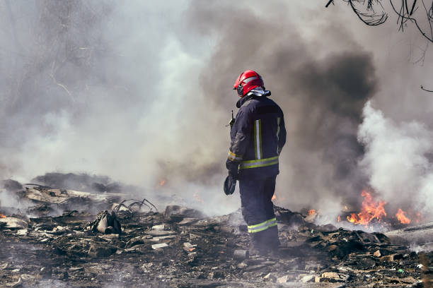 istock firefighter in extinguishing the fire on the illegal dump 1225014799