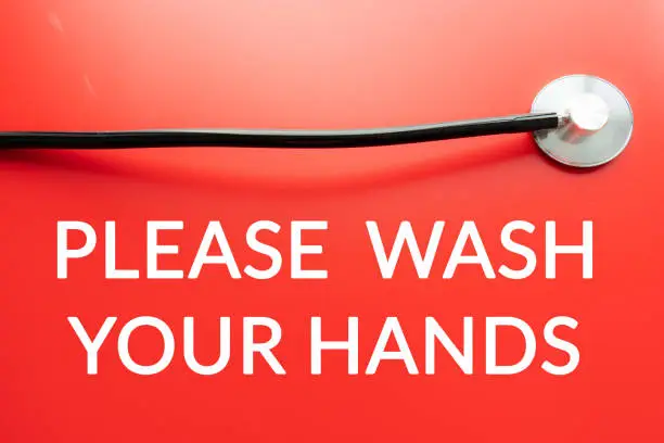 Please wash your hands notice warning at entrance sign with stethoscope for handwashing.