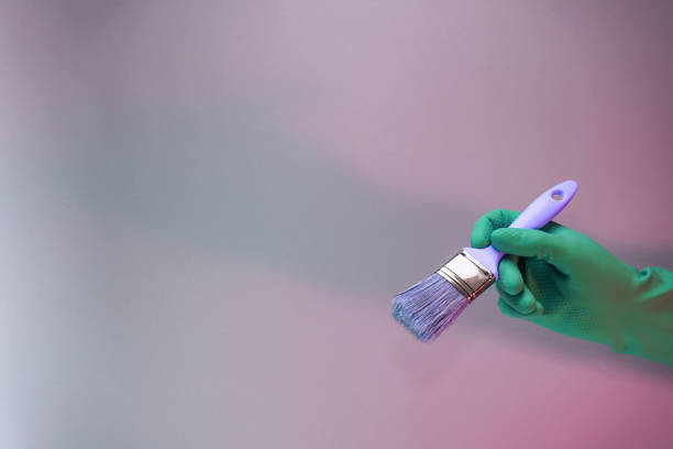istock Beutiful Hand holding paint brush in the in neon light. Minimalism retro style concept. Background pattern for design. 1225019078