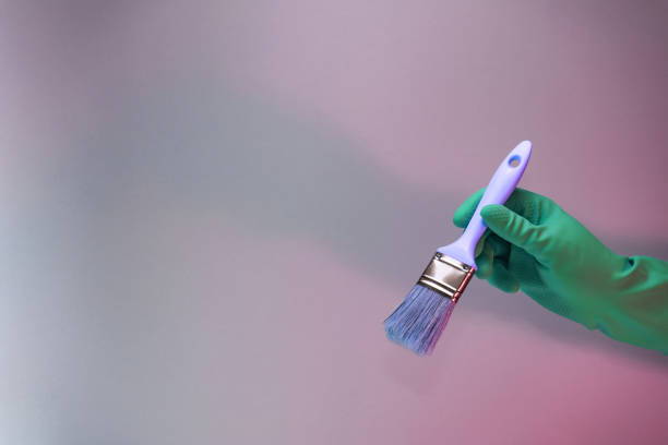istock Beutiful Hand holding paint brush in the in neon light. Minimalism retro style concept. Background pattern for design. 1225019136