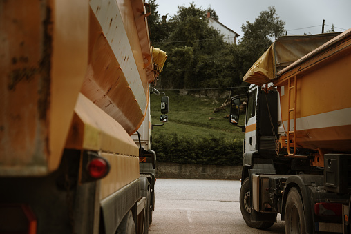 A rear view of two large trucks