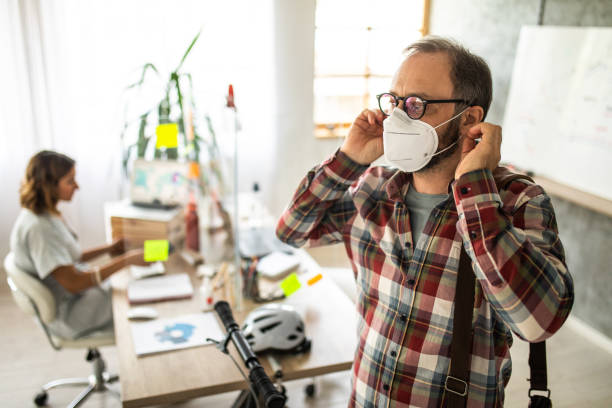 istock Businessman putting on face mask before leaving office 1225021088
