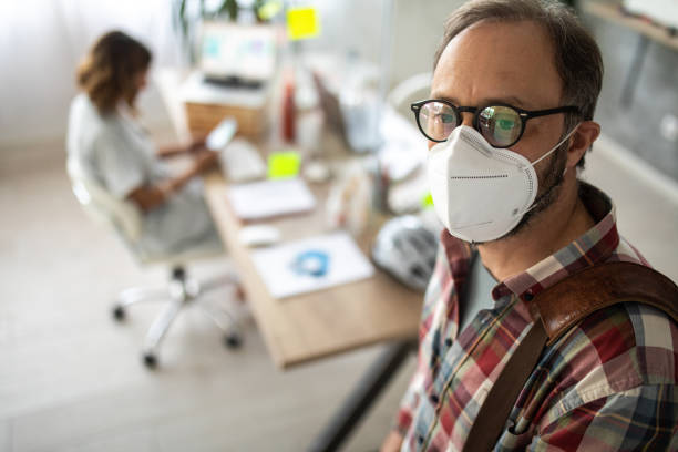 istock Businessman wearing n95 face mask 1225021151