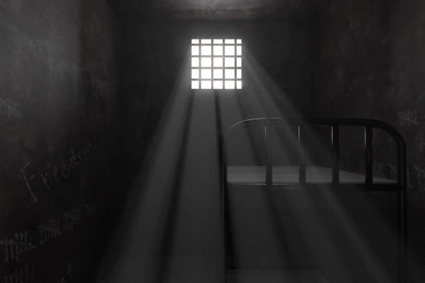 istock 3d rendering of grunge prison cell with bunk bed and light ray of window 1225023186