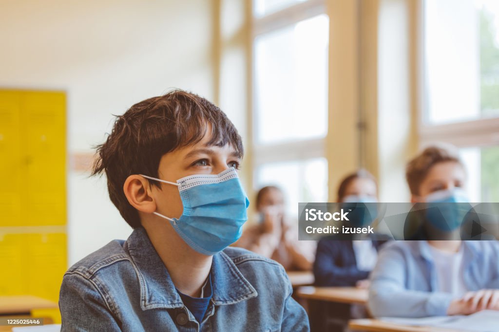 High school students at school, wearing N95 Face masks. High school students at school, wearing N95 Face masks.
Sitting in a classroom. School Building Stock Photo