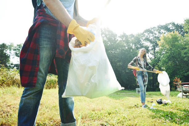 istock Young volunteers collect garbage in a public park 1225025770
