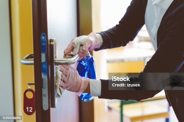 Covid19 The Teacher Wipes Down Door Handle Stock Photo - Download Image Now - School Building, Cleaning, Education