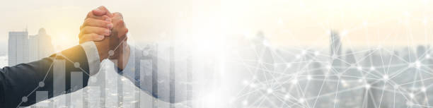 istock Double exposure business hand shake between two colleagues, greeting, dealing, merger and acquisition concept,abstract city and forex chart background with copy space. 1225027172