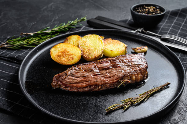 istock Barbecue dry aged wagyu flank steak.  Black background. Top view 1225028183