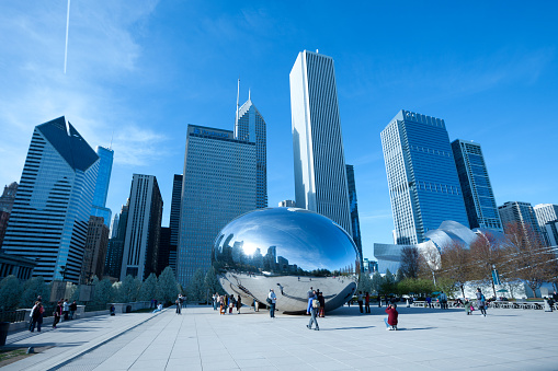 Chicago, Illinois, United States - May 04, 2011: Skyline of buildings and tourists at Millennium Park at downtown.