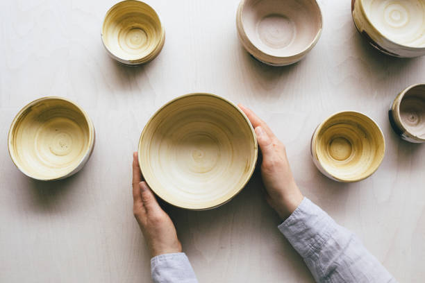 istock Handmade Ceramic Painted Bowls Held by the Artist's Hands 1225029882