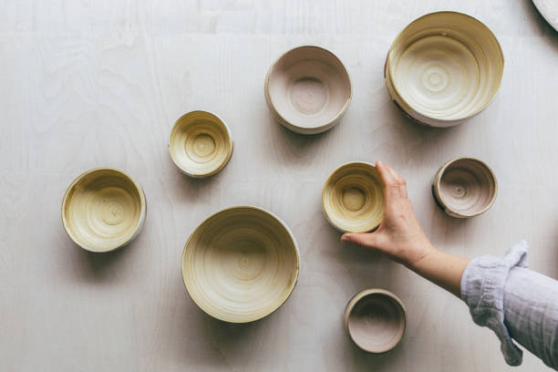 istock Handmade Ceramic Painted Bowls Held by the Artist's Hands 1225029892