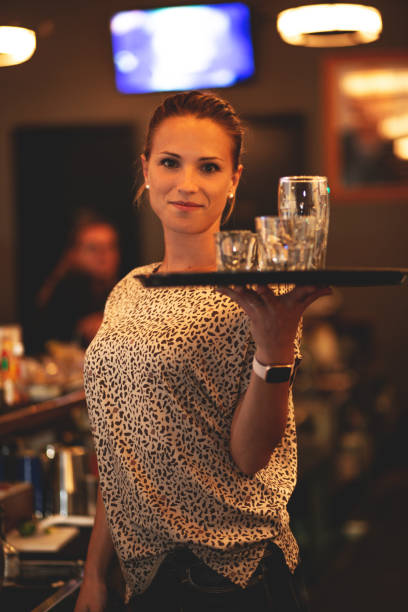 istock Young bartender girl working in a bar. 1225031245