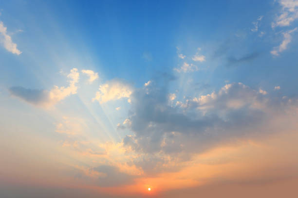 Beautiful sunlight through a clouds on blue sky background at the evening.