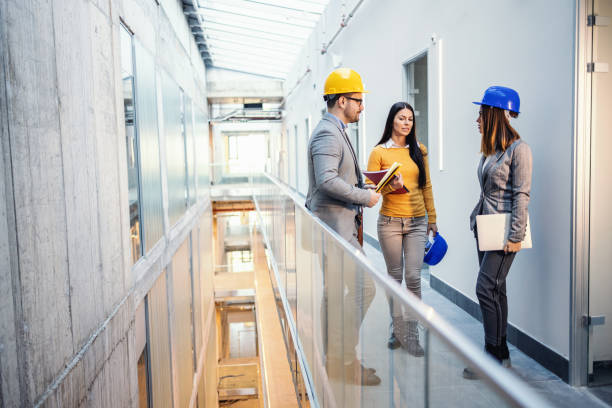 istock Three architects standing inside of future business center and talking about renewal. 1225031612