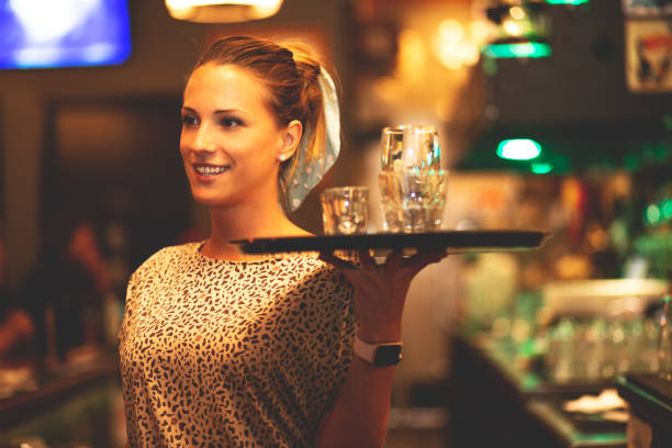 istock Young bartender girl working in a bar. 1225031656