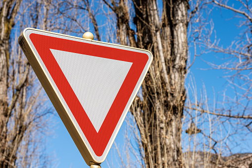 Close-up of a Yield or Give Way Road sign. Photography, Trento city, Italy, Europe