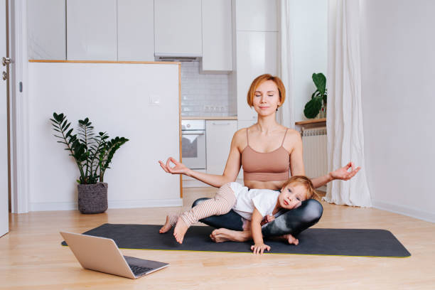 istock Toddler napping on his mother's legs while she is doing yoga at home 1225032875
