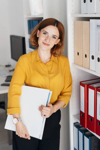 istock Attractive young businesswoman carrying a folio 1225033047