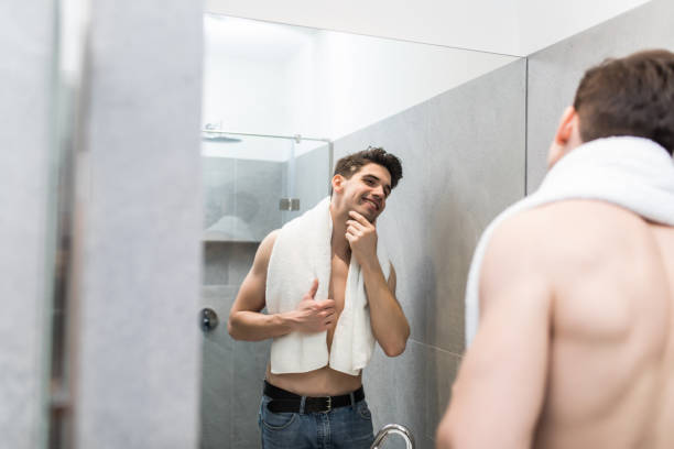 istock Attractive man drying his face in the mirror bathroom 1225033294