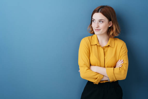 istock Young woman standing watching to the side 1225033317