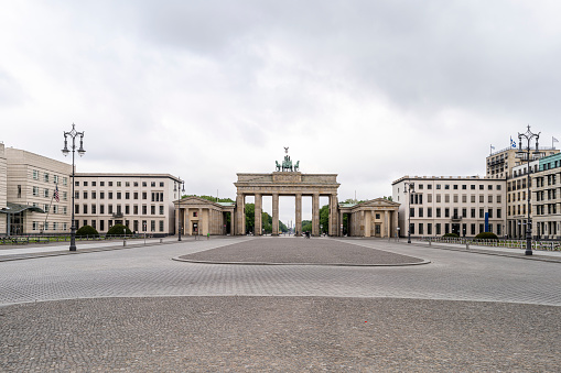 Berlin, Germany - May 3, 2020: The historic Brandenburg Gate is a landmark of Berlin, with the public space known as Pariser Platz in front, in central Berlin, Germany