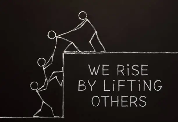 Photo of We Rise By Lifting Others Concept