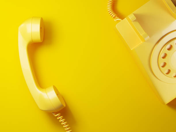 istock Vintage yellow phone receiver on a yellow background. 1225034575