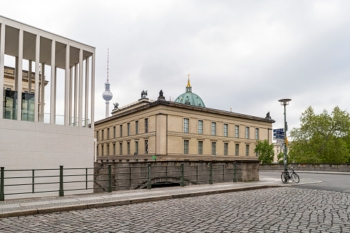 Berlin, Germany - May 3, 2020: The Eiserne Bridge, and rear of the Altes Musem (Old Museum in English), on Museum Island, in Berlin, Germany