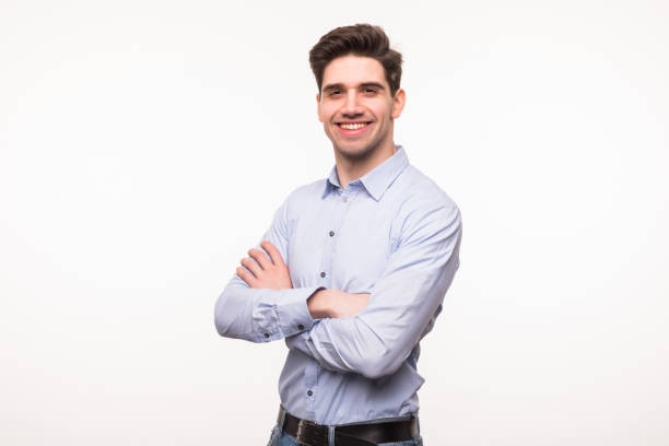 istock Portrait of a young man smiling with hands folded over a white background 1225037300