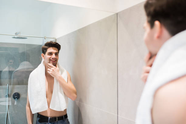 istock Attractive man drying his face in the mirror bathroom 1225039057