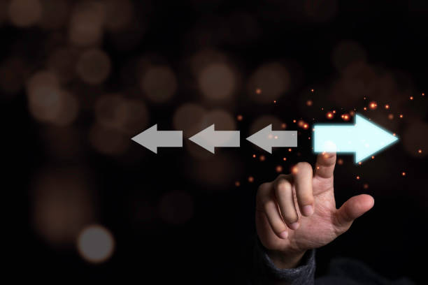 istock Hand touching light blue arrow which opposite direction with white arrow. Disruption and different thinking for discovery new technology  and new business opportunity concept. 1225040236