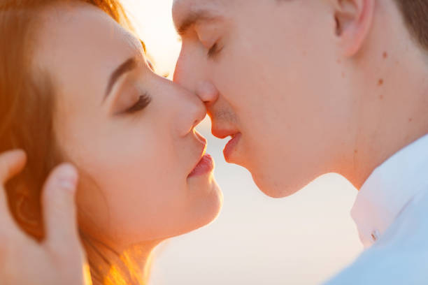 Newlyweds kisses in the desert at sunset Newlyweds kisses in a white desert during a romantic honeymoon trip. kissing on the mouth stock pictures, royalty-free photos & images