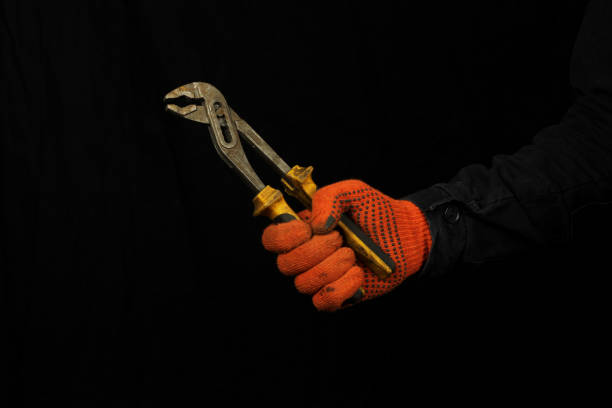 istock Mechanic hold wrench tool in hand in glove. Copy space 1225041919