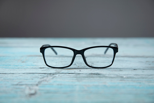 optical glasses on the blue wooden table