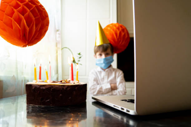 istock Upset boy in mask is forced to celebrates his birthday alone. 1225043836