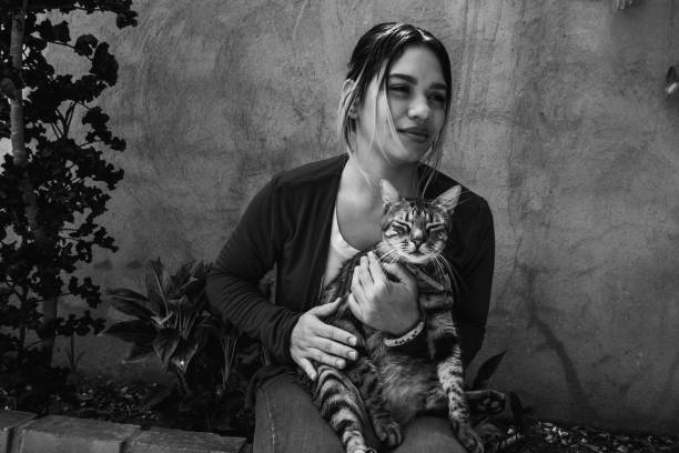 istock beautiful girl strokes a cat 1225046008