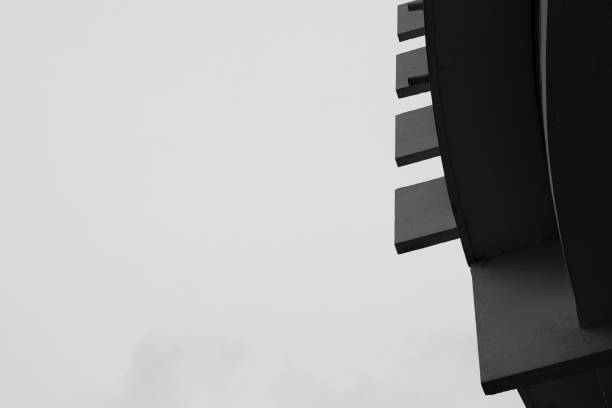 A small part of the old building, from which rectangular slabs protrude horizontally. There is a place for text. Black and white photo for your geometric design.