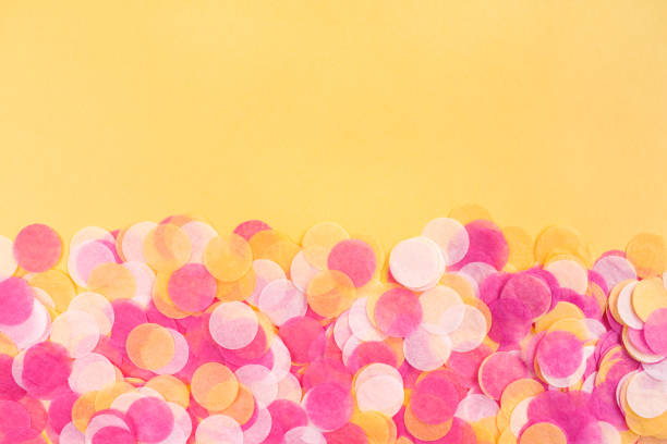 istock Orange, pink and white confetti on orange background. 1225046381