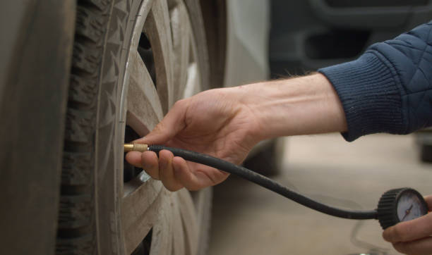istock Men's hands unscrewing a car pump 1225046470