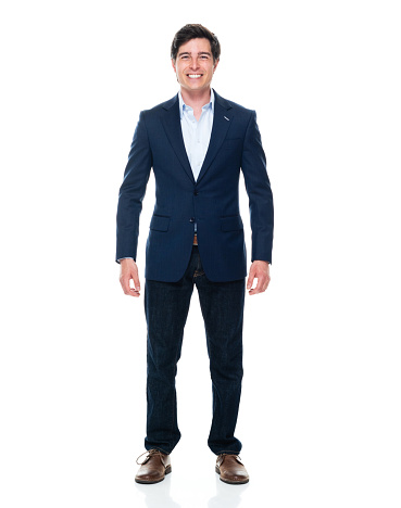 Full length of aged 20-29 years old with brown hair caucasian young male business person standing in front of white background wearing jeans