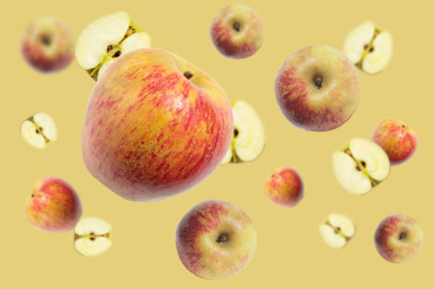 istock Levitation of a whole apple and a half on a light cream background. Image with selective focus. 1225049536