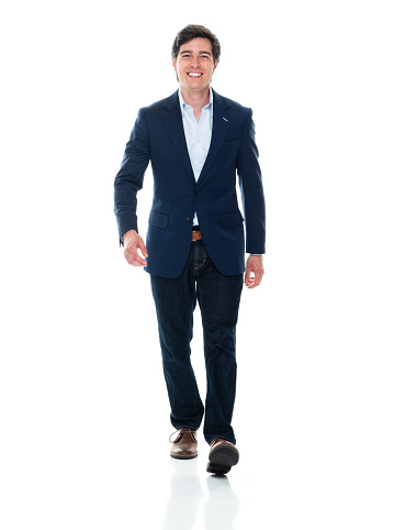 One person of aged 20-29 years old with brown hair caucasian young male business person walking in front of white background wearing smart casual who is cheerful