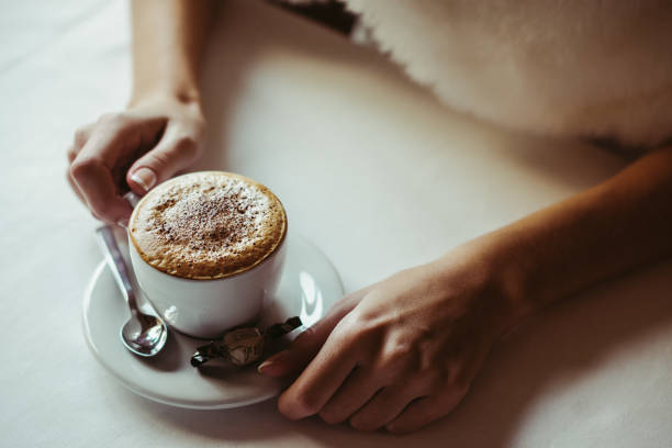 istock Coffee cappuccino with foam. Women's hands with cap 1225050897